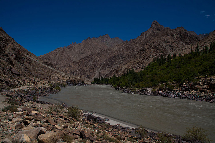 DRASS- KASHMIR-INDIA - JULY 30: A vehicle passes on a highway nest to the Indus river flowing towards Pakistan administered Kashmir on July 30, 2015 in Drass, 142 km (88 miles) east of Srinagar the summer capital of Indian administered Kashmir, India. Drass, the second coldest place on earth straddles on the Line of Control that divides Kashmir between India and Pakistan. In a region with an altitude-influenced subarctic climate, average low temperatures are around -25 C (-10 F), and as low as -45 C (-10 F) at the height of winter, which lasts from mid-October to mid-May. Drass is located in a relatively flat and open space with extensive willow groves along the river. The town shot into prominence in the summer of 1999 following a war between Pakistani and Indian army , The Kargil War saw the town being shelled by the Pakistani and Indian army and the war ended with the killings of more than 700 Indian and pakistani army soldiers in the mountainous region. In summer this town presents a pleasant look while in winter it discovered under a thick blanket of snow for half a year and communication with the outside world is cut off. Its mountain chambers hosts the second highest pass and lowest temperature in the world. The town has been home to through the centuries to only small numbers of nomads with the flock of domesticated yaks, goats and sheep. The local population have adapted to thin air and freezing temperatures. Raised uplands of rolling hills and snowy mountains lie between 16000 and 21000 feet treeless and desolate with constant winds and blizzards. (Photo by Yawar Nazir/ Getty Images)